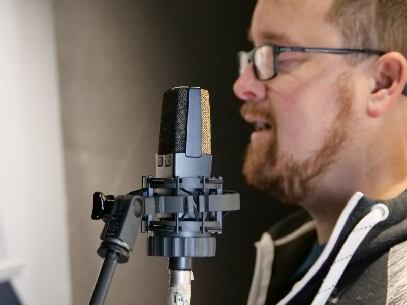 Breesy in his studio with the AKG C414XL condenser microphone