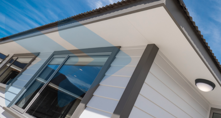 photograph of the white siding and grey eaves of the 2021 charity house, built by Otago Polytechnic students