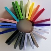 Circular arrangement of acoustic panelling pieces to showcase the colour options of this particular type of panelling