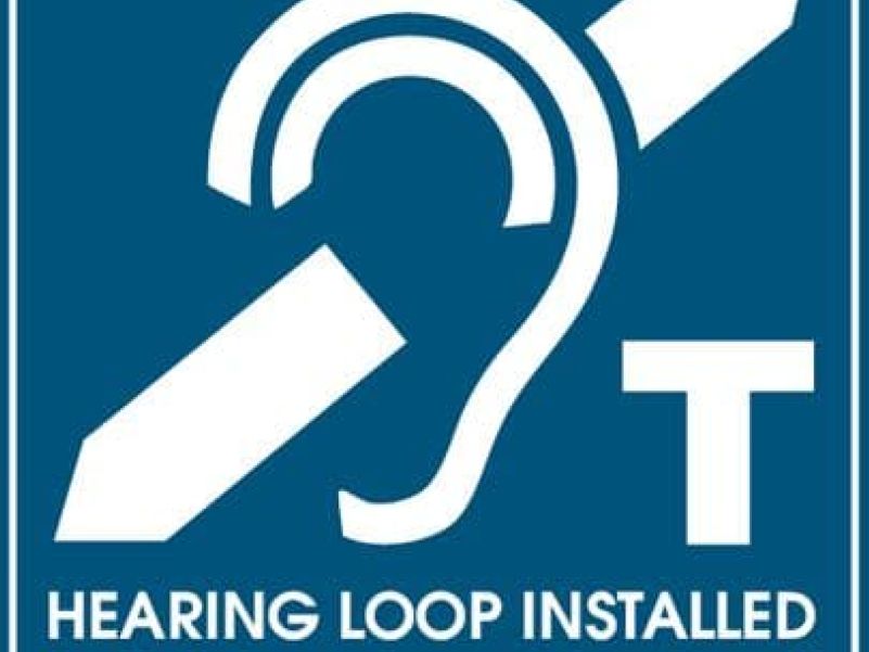Blue and white sign indicating a room has a hearing loop installed