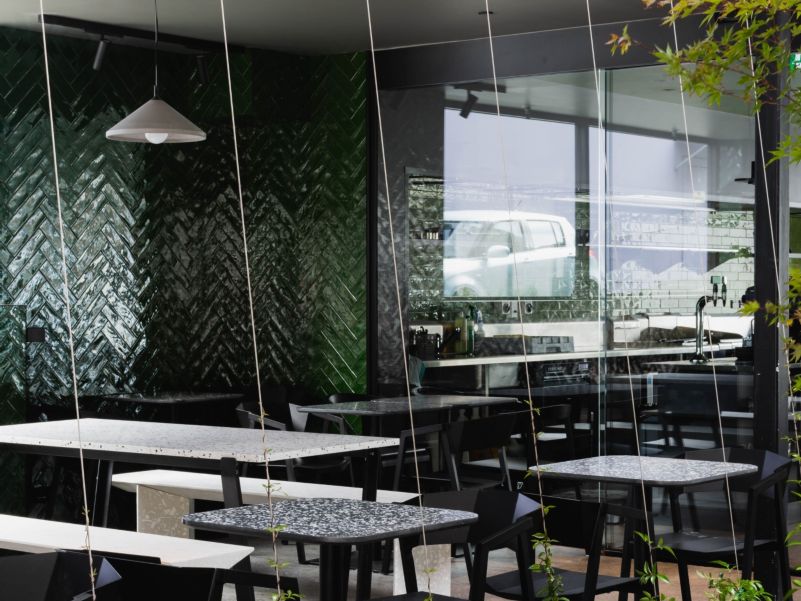 View into the cafe through its glass walls, from the courtyard