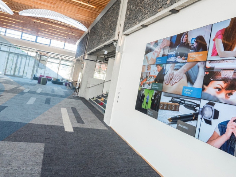 Digital Signage screen wall installed at Otago Polytechnic, with Vision's blue arrows overlayed