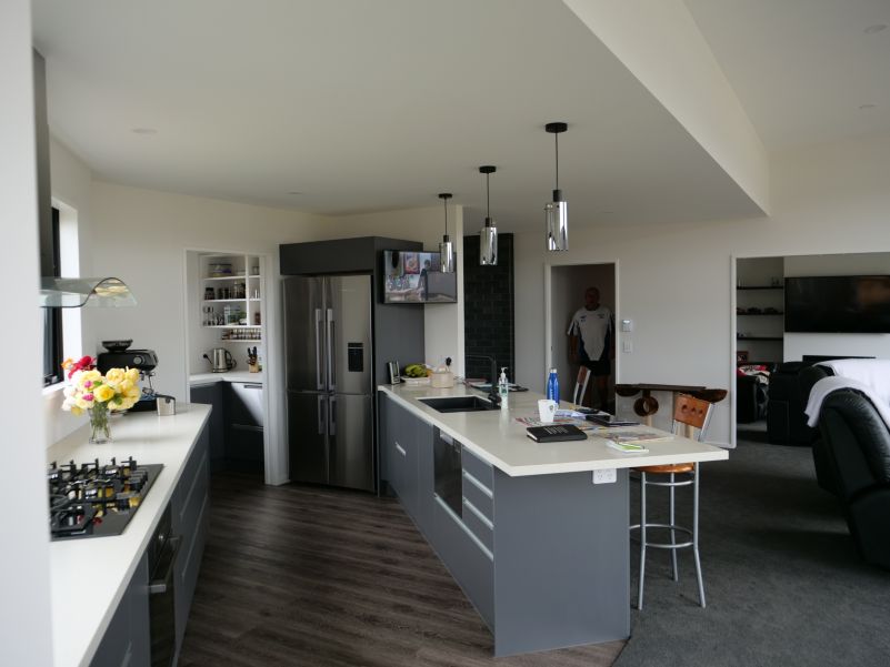 wall mounted TV installed in the kitchen, with audio from in ceiling speakers